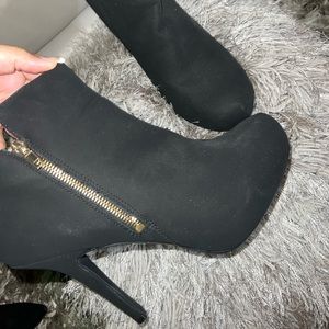 Black stiletto bootie with gold zipper. Size 11